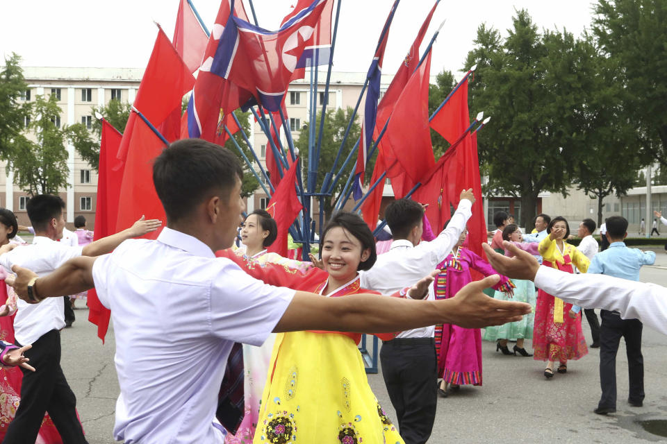 Youth and students hold dancing party for celebrating the 62nd anniversary of their late leader Kim Jong Il's first field guidance for the revolutionary armed forces, at the plaza of the Pyongyang Indoor Stadium in Pyongyang, North Korea Thursday, Aug. 25, 2022. (AP Photo/Cha Song Ho)