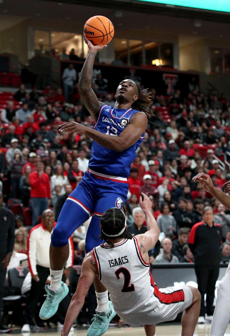Nov 14, 2022; Lubbock, Texas, USA;  Louisiana Tech Bulldogs forward David Green (13) drives to the basket over Texas Tech Red Raiders guard Pop Isaacs (2) in the first half at United Supermarkets Arena. Mandatory Credit: Michael C. Johnson-USA TODAY Sports