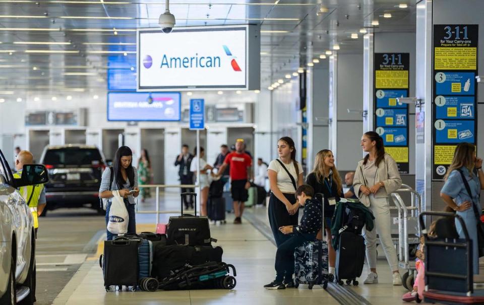 In this file photo, travelers are seen at the American Airlines departure area at the Miami International Airport on Monday, May 1, 2023, in Miami, Fla. F