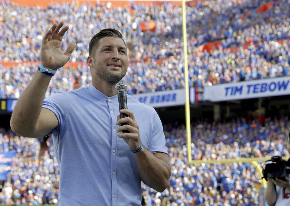 Former Florida football player Tim Tebow speaks to fans after he was inducted in the Ring of Honor at Florida Field during the first half of an NCAA college football game against LSU, Saturday, Oct. 6, 2018, in Gainesville, Fla. (AP Photo/John Raoux)