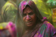 Hindu devotees play with colour during Holi celebrations at the Bankey Bihari Temple on February 28, 2010 in Vrindavan, India. The tradition of playing with colours on Holi draws its roots from a legend of Radha and the Hindu God Krishna. It is believed that young Krishna was jealous of Radha's fair complexion since he himself was himself very dark. After questioning his mother Yashoda on the darkness of his complexion, Yashoda, teasingly asked him to colour Radha's face in which ever colour he wanted. In a mischievous mood, Krishna applied colour on Radha's face. The tradition of applying colour on one's beloved is being religiously followed till date. (Photo by Daniel Berehulak/Getty Images)