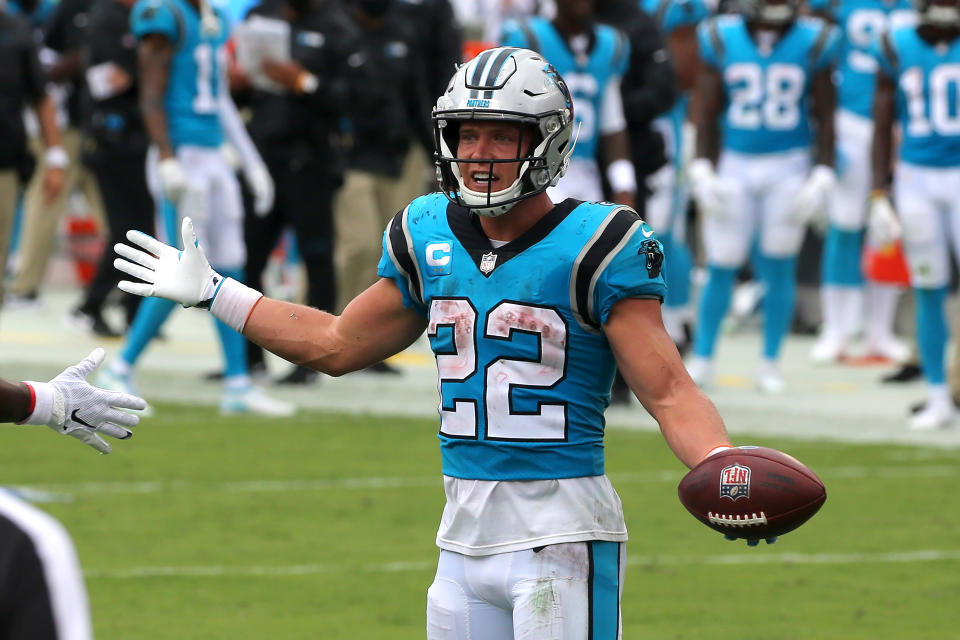 Christian McCaffrey holds the football. 