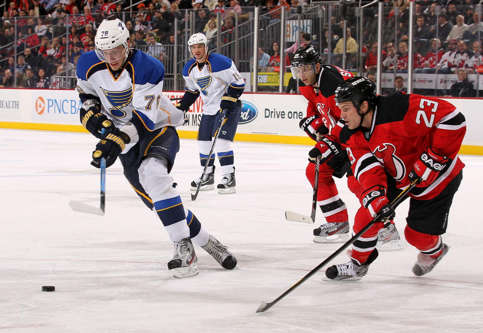 NEWARK, NJ - FEBRUARY 09: Evgeny Grachev #78 of the St Louis Blues skates with the puck under pressure from David Clarkson #23 of the New Jersey Devils at Prudential Center on February 9, 2012 in Newark, New Jersey. (Photo by Nick Laham/Getty Images)