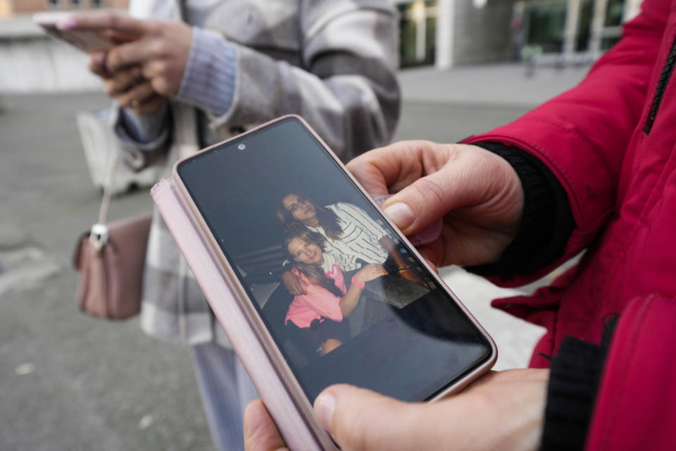 Verkalets Olha from Ukraine, shows her smartphone with pictures of her Pakistani-born friend Sana Cheema outside the Law court in Brescia, northern Italy, Thursday, Feb. 9, 2023, after testifying in a hearing of the trial for her murder. Courageous refusal by young immigrant women in Italy to submit to forced marriages sometimes carries a deadly price. In separate murder trials, Italy is seeking justice for Pakistani-origin women who were allegedly strangled by relatives angered by their defiance of forced marriage. (AP Photo/Luca Bruno)