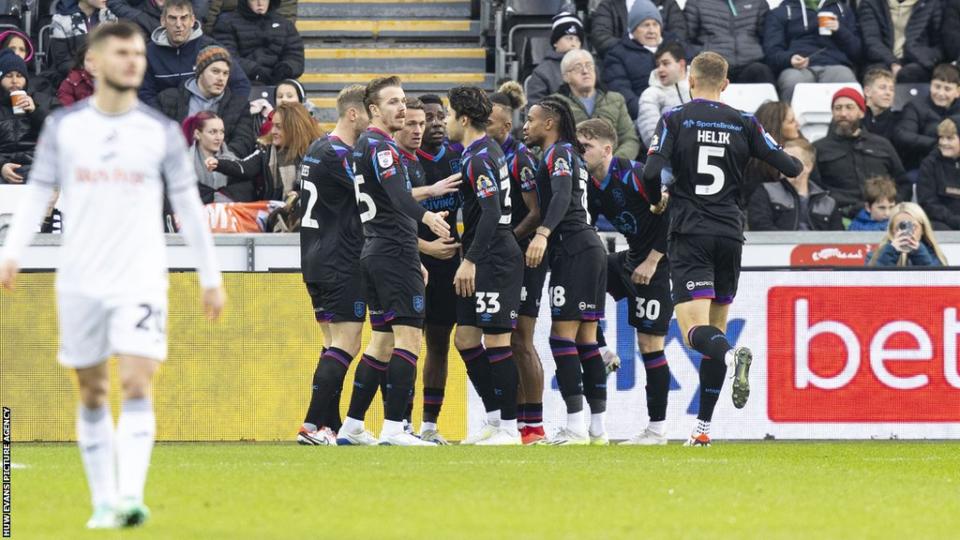 Huddersfield players celebrate Ben Cabango's own goal