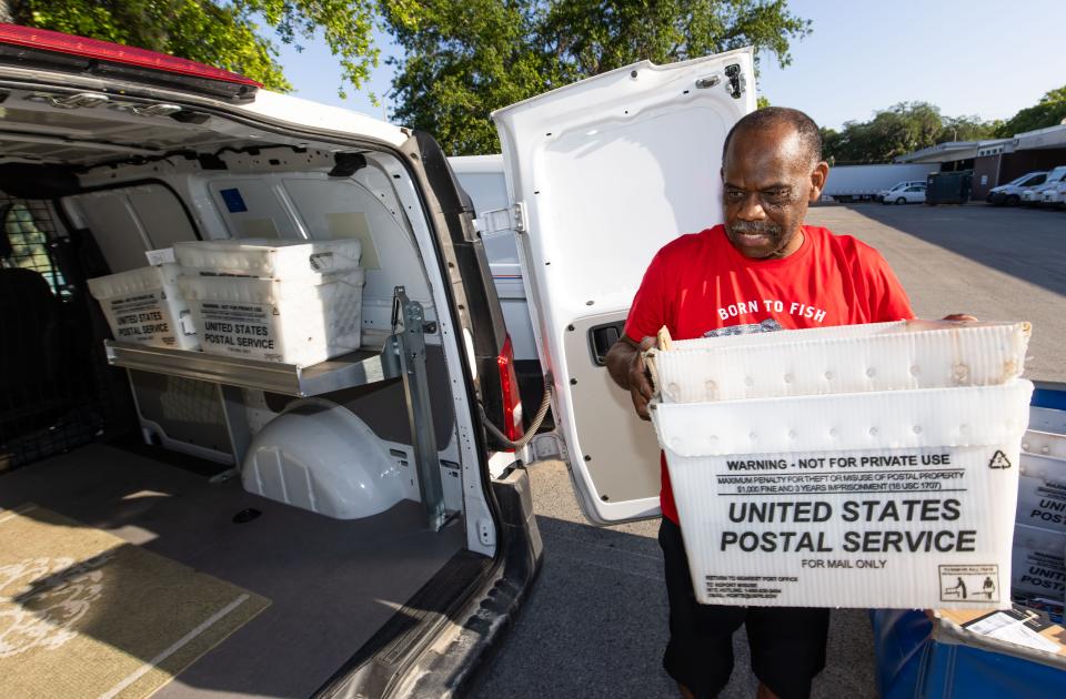 Postal worker and rural carrier Mike Walker loads his truck on May 3. He will be among the carriers helping with Saturday's annual food drive.
