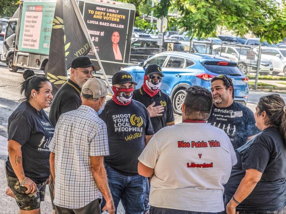 People holding a Proud Boys flag and wearing T-shirts with the group’s symbols stand outside of the Miami-Dade County School Board building on Wednesday September 06, 2023.
