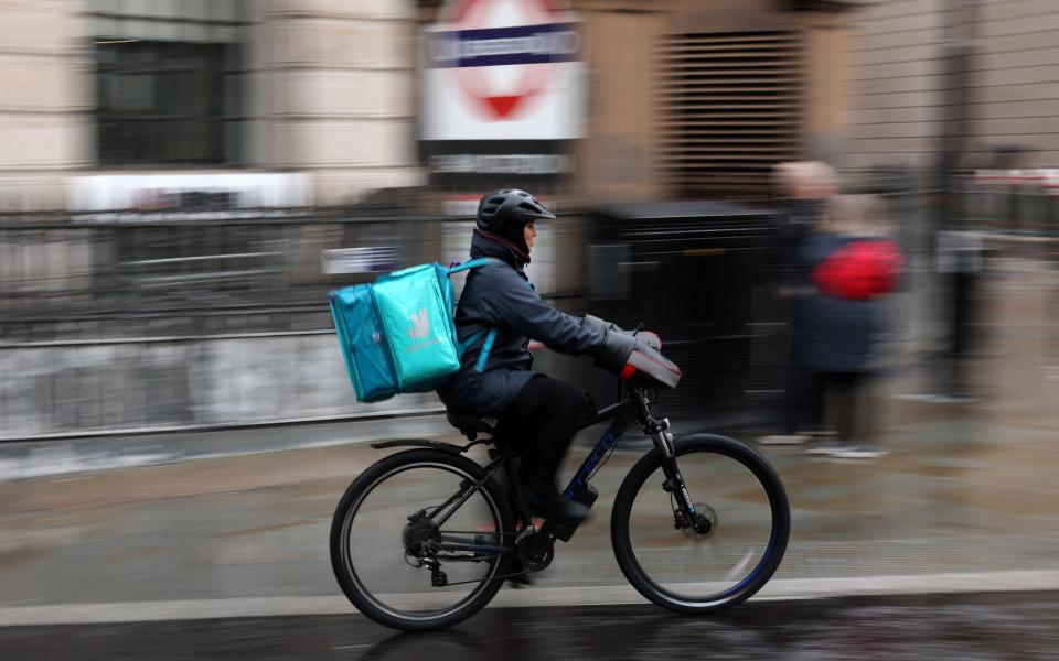 A Deliveroo rider on an electric bike in the City of London earlier this month
