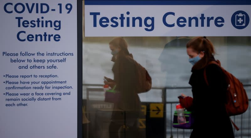 A passenger walks past a testing centre outside the terminal building of Manchester Airport amid the outbreak of the coronavirus disease (COVID-19) in Manchester
