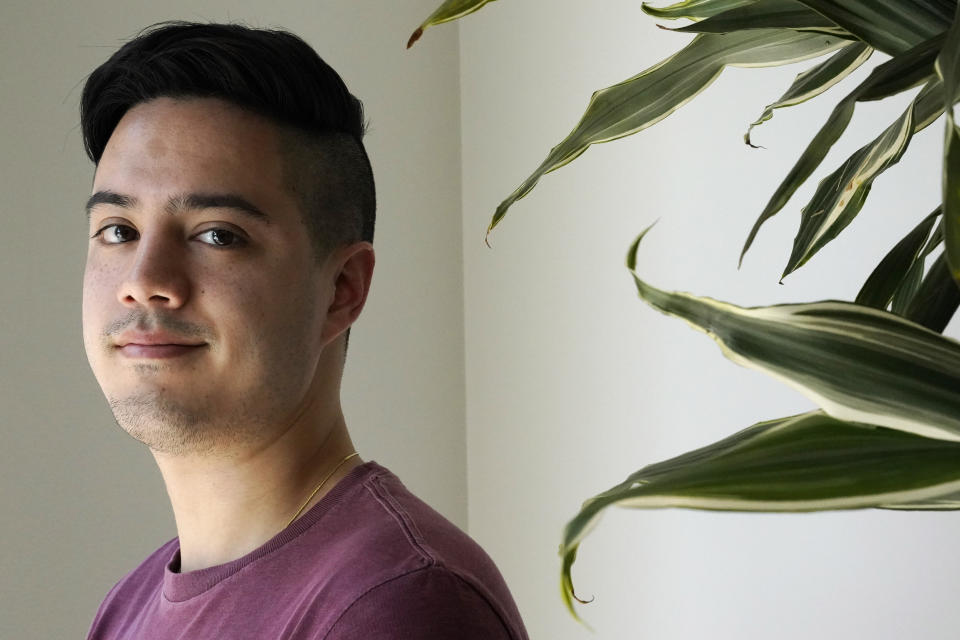 Benjamin Beltran, 26, poses for a portrait, Tuesday Aug. 18, 2020, in Washington. For most of his childhood, Beltran identified with his dad’s roots as a Filipino growing up. At times, that made his white mother worry he was forgetting her ancestry, which traces to Scotland and Ireland. (AP Photo/Jacquelyn Martin)