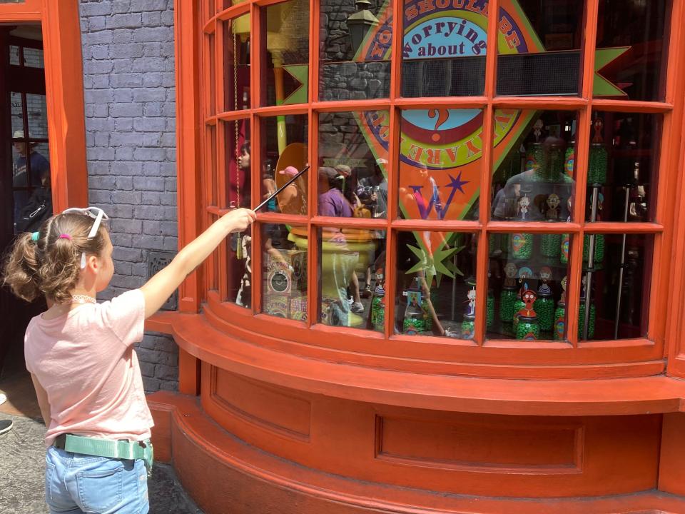 lisa galek daughter pointing wand a shop