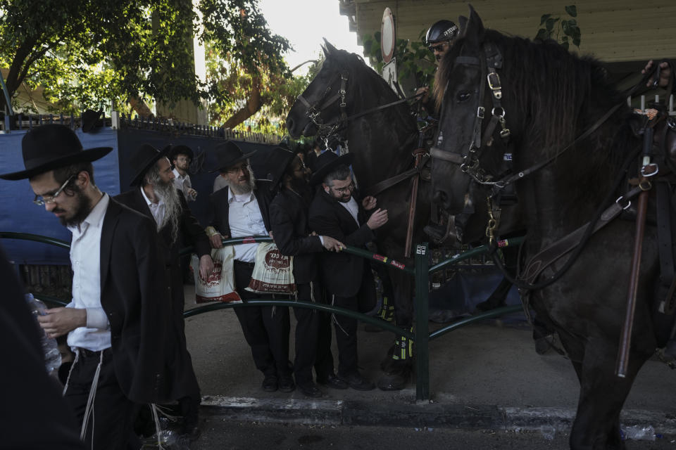 Israeli mounted police officers disperse Ultra-Orthodox Jews blocking a highway during a protest against army recruitment in Bnei Brak, Israel, Thursday, June 27, 2024. Israel's Supreme Court unanimously ordered the government to begin drafting ultra-Orthodox Jewish men into the army — a landmark ruling seeking to end a system that has allowed them to avoid enlistment into compulsory military service. (AP Photo/Oded Balilty)