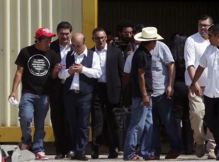 Mexico's Attorney General Jesus Murillo Karam (3rd L) walks with others after a meeting with relatives of the 43 missing students of the Ayotzinapa teachers' training college, at a hangar at an airstrip of Mexico's Federal Police in Chilpancingo November 7, 2014. REUTERS/Daniel Becerril