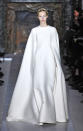 <b>Valentino SS13 </b><br><br>Models' bodies were completely covered up in full-length white gowns that featured cape-like arms.<br><br>© Rex