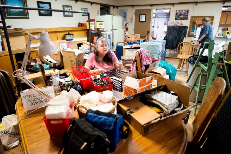 Pat Cantrell, 73, sorts through and organizes a pile of silverware to help pack the belongings of the Spana-Park Senior Center, which is being evicted from its Parkland home. Cantrell has been visiting the center two times a week for five years to attend a quilting class, where she says, “We had a ball being together and doing things together.”