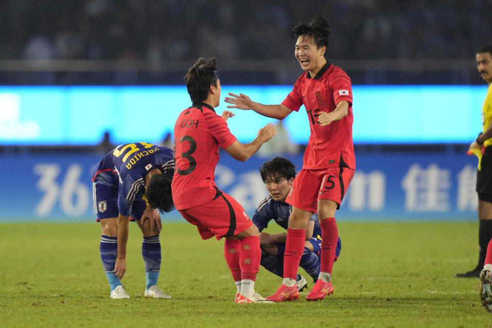 South Korea's Goh Youngjun, left, and Jung Hoyeon celebrate after defeating Japan in their men's soccer gold medal match at the 19th Asian Games in Hangzhou, China, Saturday, Oct. 7, 2023. (AP Photo/Aijaz Rahi)