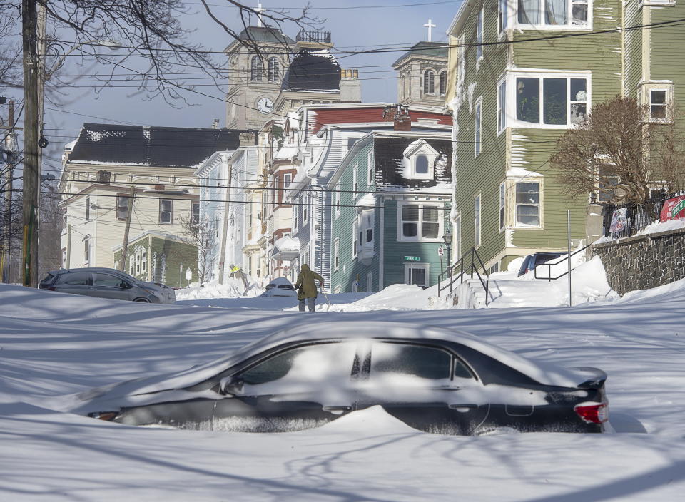 A half buried car is parked in St. John's, Newfoundland and Labrador, on Saturday, Jan. 18, 2020. The state of emergency ordered by the City of St. John's is still in place, leaving businesses closed and vehicles off the roads in the aftermath of the major winter storm that hit the Newfoundland and Labrador capital. (Andrew Vaughan/The Canadian Press via AP)