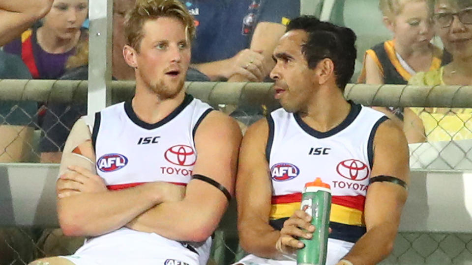 Rory Sloane and Eddie Betts are pictured talking on the bench during an Adelaide Crows match.