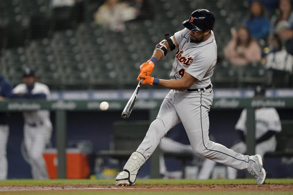 Detroit Tigers' Jeimer Candelario grounds out to first, allowing Robbie Grossman to score from third during the third inning of a baseball game against the Seattle Mariners, Tuesday, May 18, 2021, in Seattle. (AP Photo/Ted S. Warren)