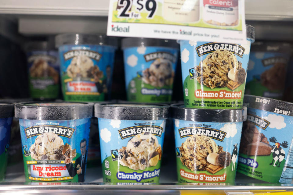 Ben & Jerry's ice cream pints on store shelves, featuring flavors like Americone Dream, Chunky Monkey, and Gimme S'more!