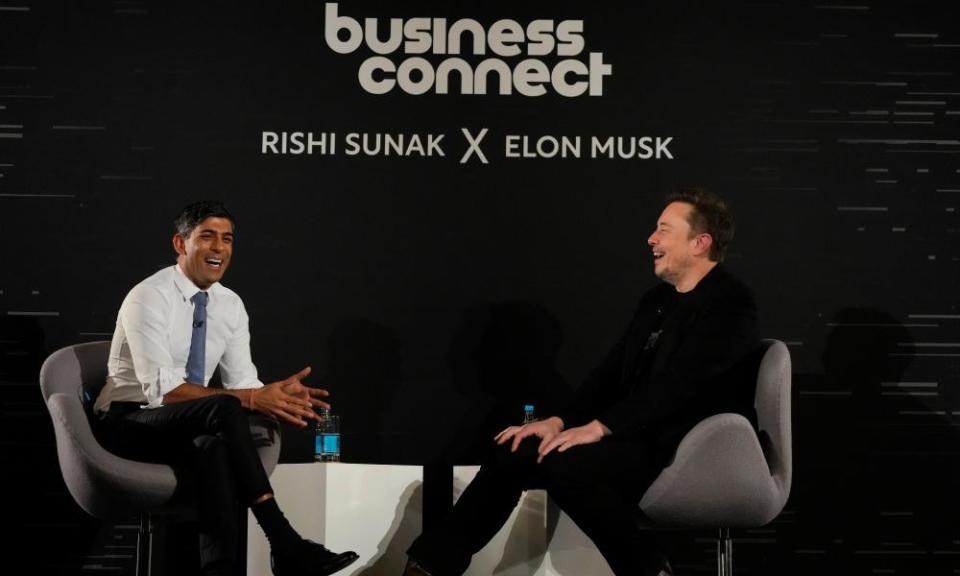 Rishi Sunak and Elon Musk laughing while sitting in chairs in front of a sign reading ‘Business connect: Rishi Sunak X Elon Musk’