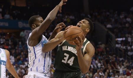 Oct 17, 2018; Charlotte, NC, USA; Milwaukee Bucks forward Giannis Antetokounmpo (34) tries to shoot against Charlotte Hornets forward Michael Kidd-Gilchrist (14) during the second half at the Spectrum Center. The Bucks won 113-112. Mandatory Credit: Sam Sharpe-USA TODAY Sports