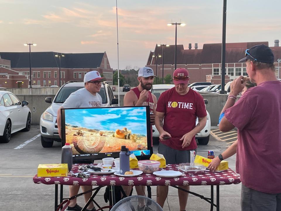 Florida State fans "review a play" from their tailgate at the top of the Spirit Way Parking garage.