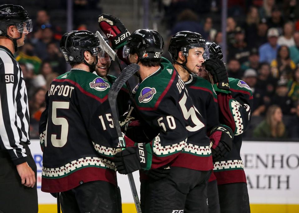 Arizona Coyotes players celebrate a goal during the second period of their exhibition game at Acrisure Arena in Palm Desert, Calif., Sunday, Oct. 1, 2023.