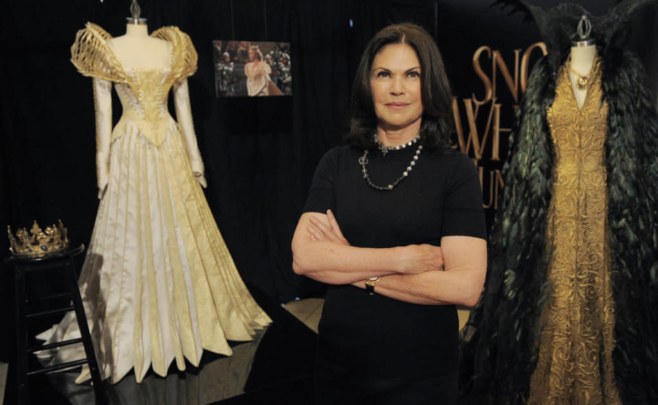 <b>Haute-Couture Queen</b><br>For costuming, SWATH employed one of the best in the business, three-time Academy Award-winning costume designer Colleen Atwood (“Alice in Wonderland” 2010, ”Memoirs of a Geisha” 2005, “Chicago” 2002). Hundreds of costumes were required for the film, including 12 major costumes just for Theron’s Queen Ravenna, all of which required hundreds of hours of labor. “There’s a collar made of Stag Beetle horns. There’s actually a dress made of beetle wings in her wardrobe. There’s a wedding dress for her, which is at the beginning of the movie, that has a huge collar made out of really fine, almost skeletal type bones. She also has a cape made of cock feathers that have been carved and sculpted into a shape on a cape. I call it her transforming cape because she becomes birds when she wears it. So all in all she’s quite the haute-couture sort of queen, but with an aged, rotting edge to her,” <a href="http://movies.yahoo.com/video/ymovies-6393699/snow-white-the-huntsman-featurette-costumes-28731533.html" data-ylk="slk:says Atwood;elm:context_link;itc:0;sec:content-canvas;outcm:mb_qualified_link;_E:mb_qualified_link;ct:story;" class="link  yahoo-link">says Atwood</a>.