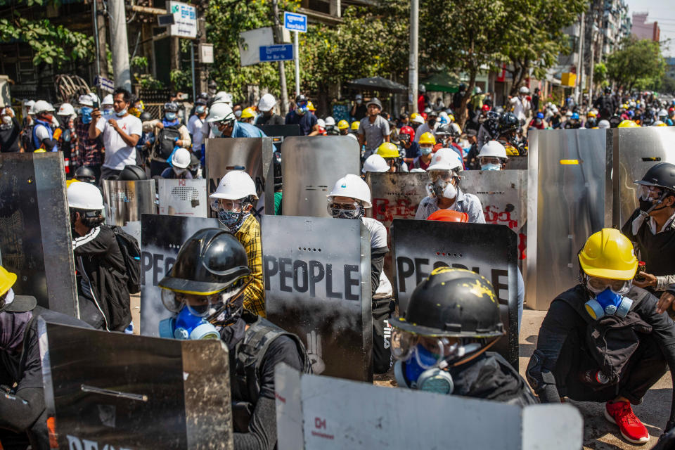 Anti-coup protesters protect themselves on Monday behind makeshift shields during a demonstration against the takeover of the government by the military following an election. Police attackers the demonstrators with rubber bullets, live ammunition, tear gas and stun bombs. (Photo: Photo by Aung Kyaw Htet/SOPA Images/LightRocket via Getty Images)