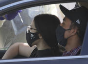 People are vaccinated while sitting inside their vehicles at a mass COVID-19 vaccination site outside The Forum in Inglewood, Calif., Tuesday, Jan. 19, 2021. California has become the first state to record more than 3 million known coronavirus infections, according to a tally Monday by Johns Hopkins University. (AP Photo/Damian Dovarganes)