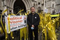 Chinese artist Ai Wei Wei joins supporters of Julian Assange as they stage a demonstration outside the High Court in London, Wednesday, Oct. 27, 2021. The U.S. government is scheduled to ask Britain's High Court to overturn a judge's decision that WikiLeaks founder Julian Assange should not be sent to the United States to face espionage charges. A lower court judge refused extradition in January on health grounds, saying Assange was likely to kill himself if held under harsh U.S. prison conditions. (AP Photo/Kirsty Wigglesworth)