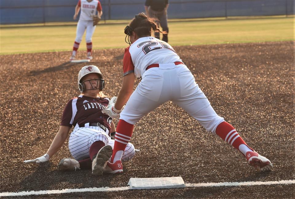 Hermleigh third baseman Mia Pence, right, tags out Eula's Brayli Collins, who was trying to steal third in the first inning.