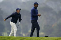 Rory McIlroy of Northern Ireland, and Tiger Woods walks off 16th tee during the first round of the PGA Championship golf tournament at TPC Harding Park Thursday, Aug. 6, 2020, in San Francisco. (AP Photo/Charlie Riedel)