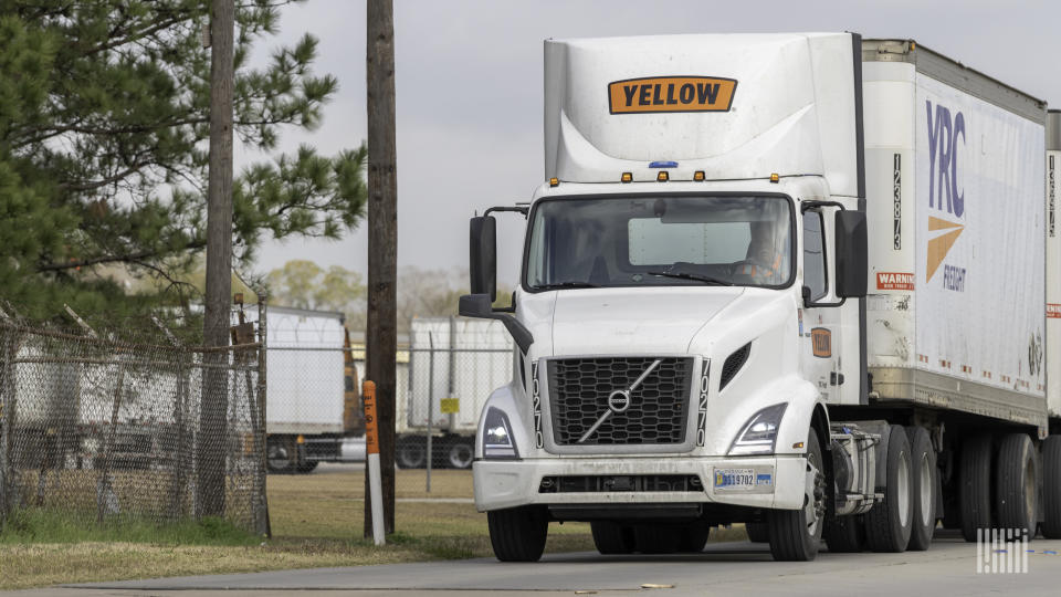 a Yellow tractor with two YRC trailers at a terminal in Houston