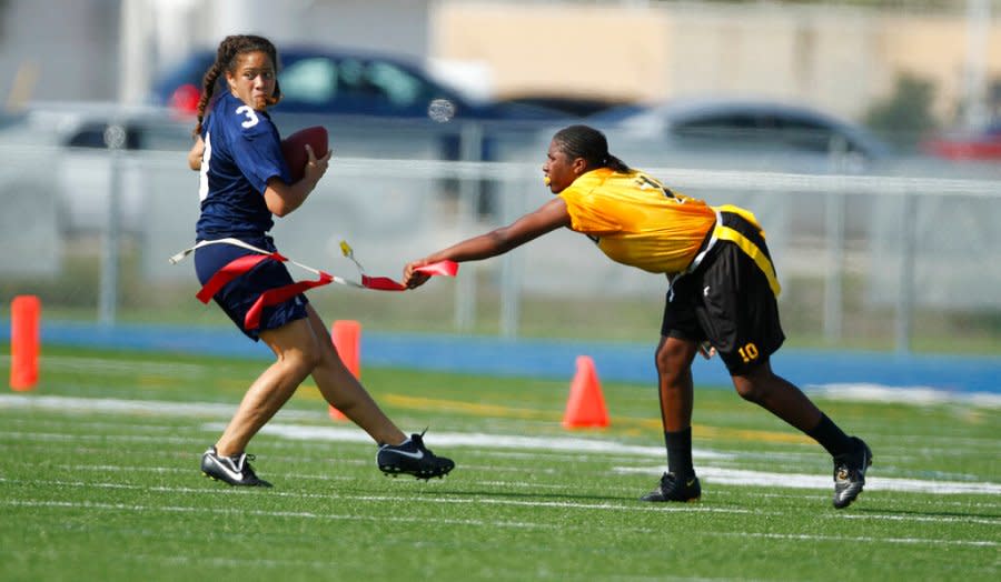 Lakewood's Paige Johnson (10) pulls the flag off Alonso's Sarah Peterika during a quarterfinal in the state high school flag football tournament in Boca Raton, Fla., Friday, May 7, 2010. An estimated 5,000 girls competed this spring at the varsity level in Florida, where the state has recognized a high school champion since 2003. (AP Photo/J Pat Carter)