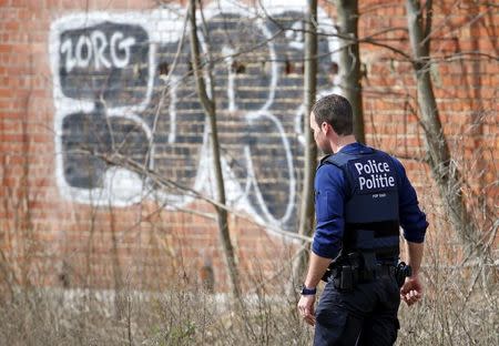 A Belgian police officer patrols during a police search operation of an apartment complex in the central Brussels district of Etterbeek, April 9, 2016, which ended without any arrests made after the building's residents were evacuated. REUTERS/Yves Herman