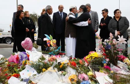 Imam Ibrahim Abdul Halim of the Linwood Mosque is embraced by Father Felimoun El-Baramoussy from the Coptic Church in Christchurch, New Zealand March 18, 2019. REUTERS/Edgar Su