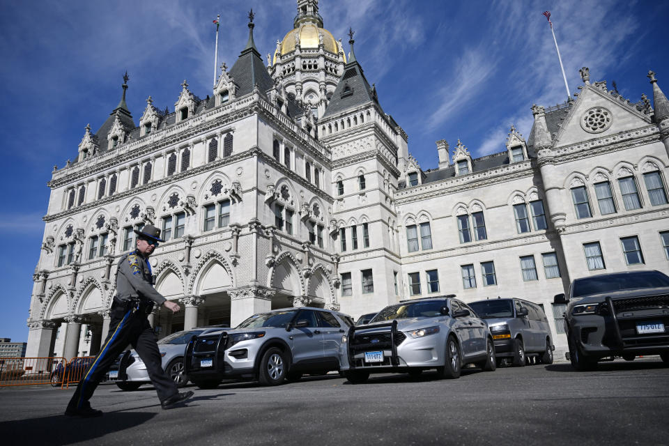 A heavier than usual police presence is stationed outside the Connecticut State Capitol on the opening session of legislature, Wednesday, Feb. 7, 2024, in Hartford, Conn. (AP Photo/Jessica Hill)