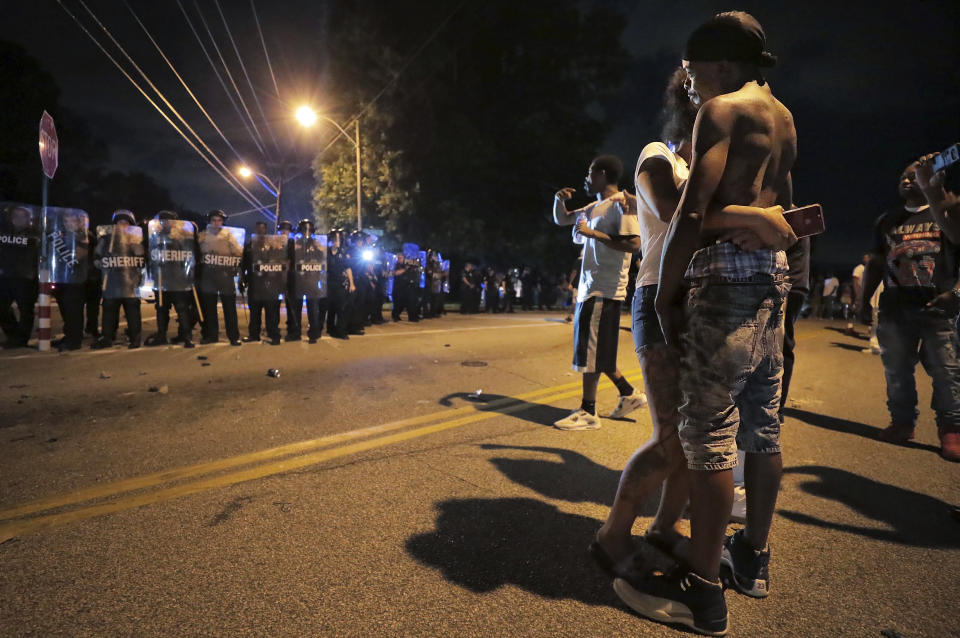 A man identified as Sonny Webber, right, father of Brandon Webber who was reportedly shot by U.S. Marshals earlier in the evening, joins a standoff as protesters take to the streets of the Frayser community in anger against the shooting, Wednesday, June 12, 2019, in Memphis, Tenn. (Photo: Jim Weber/Daily Memphian via AP)