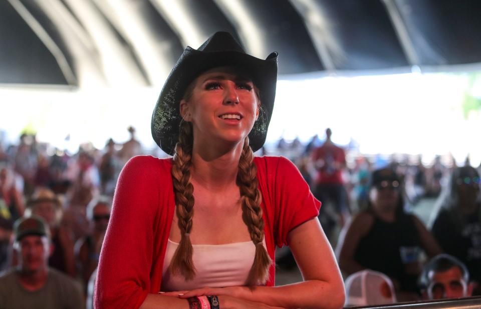 Britt Klocko of Dallas watches Rhiannon Giddens perform on the Palomino Stage during the Stagecoach country music festival in Indio, Calif., Sunday, May 1, 2022.