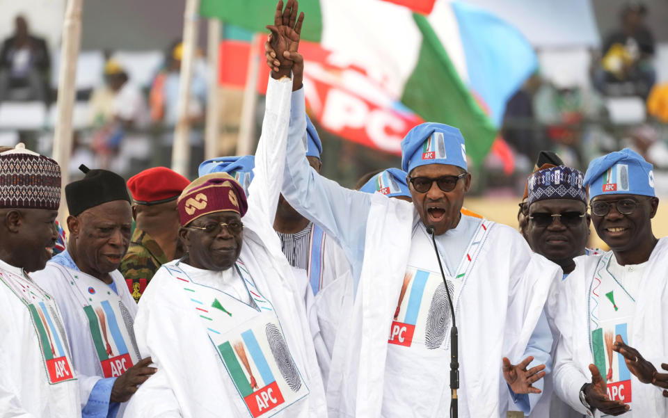 FILE- Nigeria's President, Muhammadu Buhari, center right, Bola Ahmed Tinubu, presidential candidate of the All Progressives Congress, Nigeria ruling party, center left, during an election campaign rally at the Teslim Balogun Stadium in Lagos Nigeria, Tuesday, Feb. 21, 2023. The growing security crisis presents a huge challenge for Nigeria's incoming President, Bola Tinubu, who rose to power on promises of improving the living conditions of communities whose lives have been impacted by the violence and addressing the root causes of the crisis by providing jobs and ensuring justice. But if the violence isn't reigned in, analysts say it could destabilize the country and drive more of its 216 million people further into poverty. (AP Photo/Sunday Alamba, File)