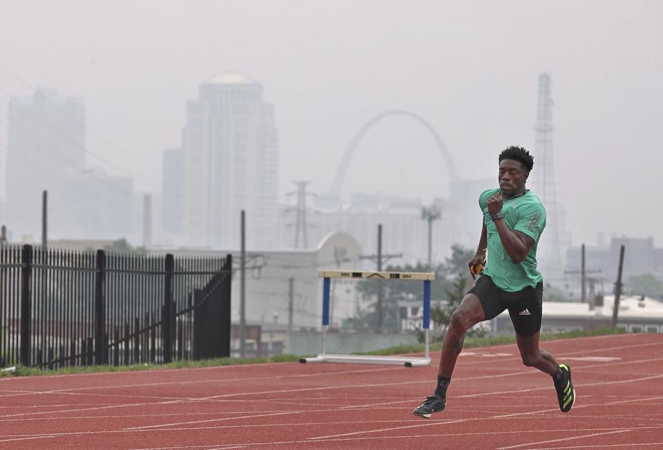 Smoke from the Canadian wildfires obscures the St. Louis skyline as Keith Major runs sprints on the track at St. Louis University, Wednesday, June 28, 2023. Major, a police officer in the city of St. Louis, is training for the World Police and Fire Games that is being held in Winnipeg, He said he was concerned about the air quality and compared training in the smoky air to training at high altitudes.  / Credit: David Carson/St. Louis Post-Dispatch via AP