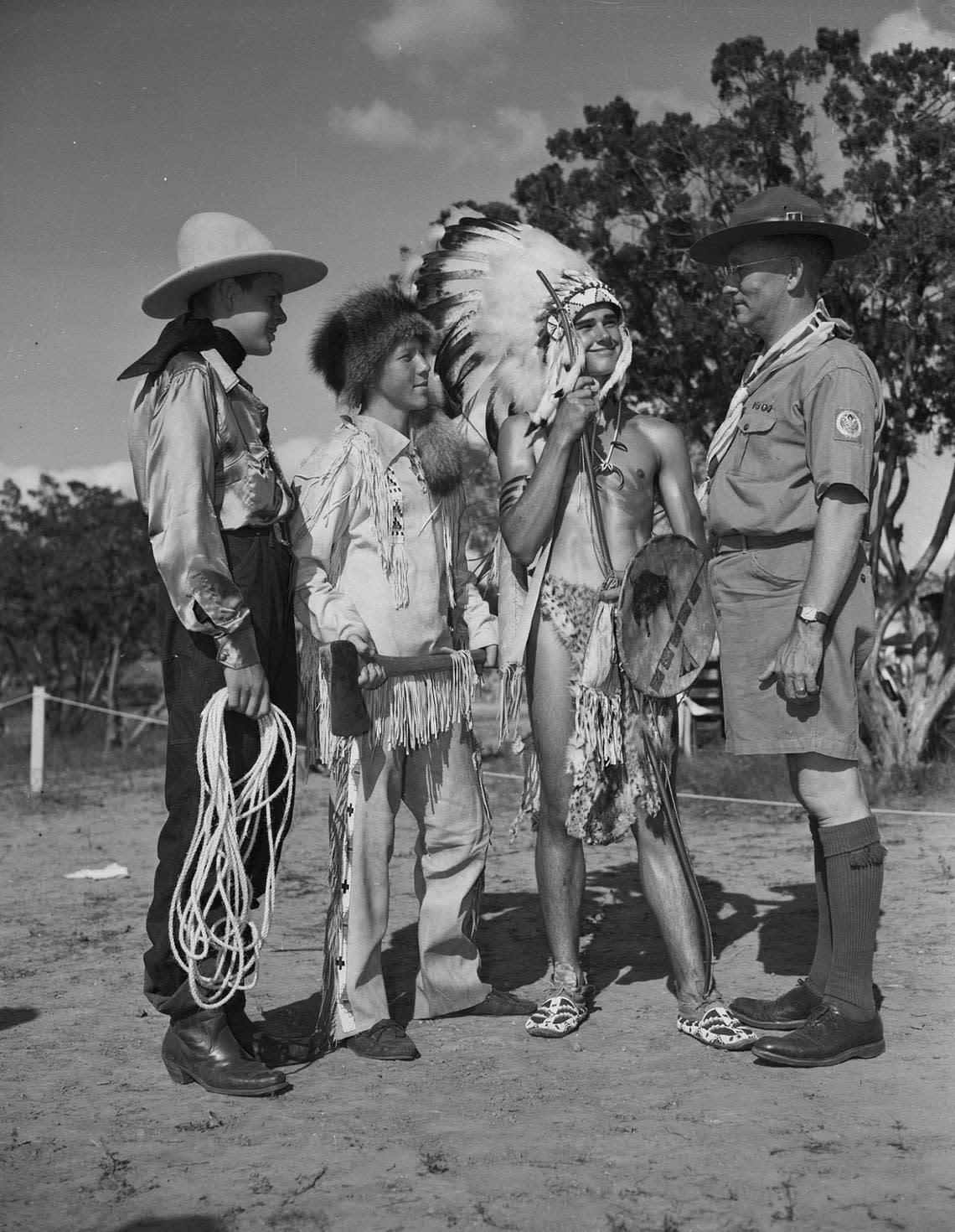 June 23, 1940: At the re-dedication ceremony of Worth Ranch, Boy Scout camp in Palo Pinto County, Scout Commissioner D.H.B. Todd, far right, inspects the pageant costumes of three scouts, from left, Charles Moore, of Arlington, dressed as a cowboy, Earl Finkle of Arlington Heights, Fort Worth, dressed as a woodsman, and George Dickey of Arlington, dressed in Native American attire. Fort Worth Star-Telegram archive/UT Arlington Special Collections