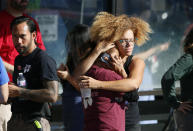 <p>Unidentified Trader Joe’s supermarket employees after being evacuated by Los Angeles Police after a gunman barricaded himself inside a Trader Joe’s store in Los Angeles on Saturday. Police believe a man involved in a standoff at the Los Angeles supermarket shot his grandmother and girlfriend and then fired at officers during a pursuit before he crashed into a utility pole outside the supermarket and ran inside the store. (Photo: Damian Dovarganes/AP) </p>