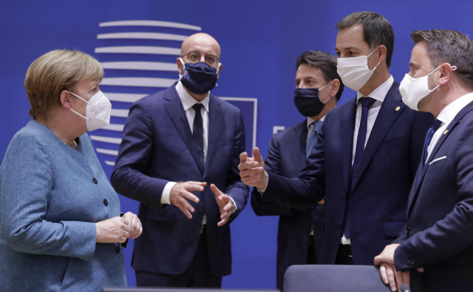 German Chancellor Angela Merkel, left, speaks with from right, Luxembourg's Prime Minister Xavier Bettel, Belgium's new Prime Minister Alexander De Croo, Italy's Prime Minister Giuseppe Conte and European Council President Charles Michel during a round table meeting at an EU summit at the European Council building in Brussels, Thursday, Oct. 1, 2020. European Union leaders are meeting to address a series of foreign affairs issues ranging from Belarus to Turkey and tensions in the eastern Mediterranean. (Olivier Hoslet, Pool via AP)