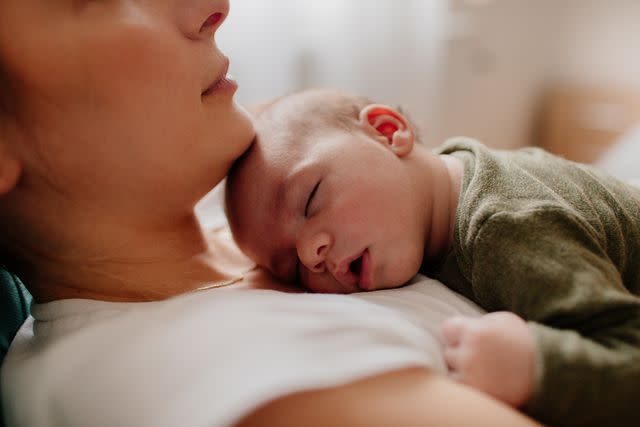 <p>Getty Images</p> Stock image of a woman with a newborn baby.