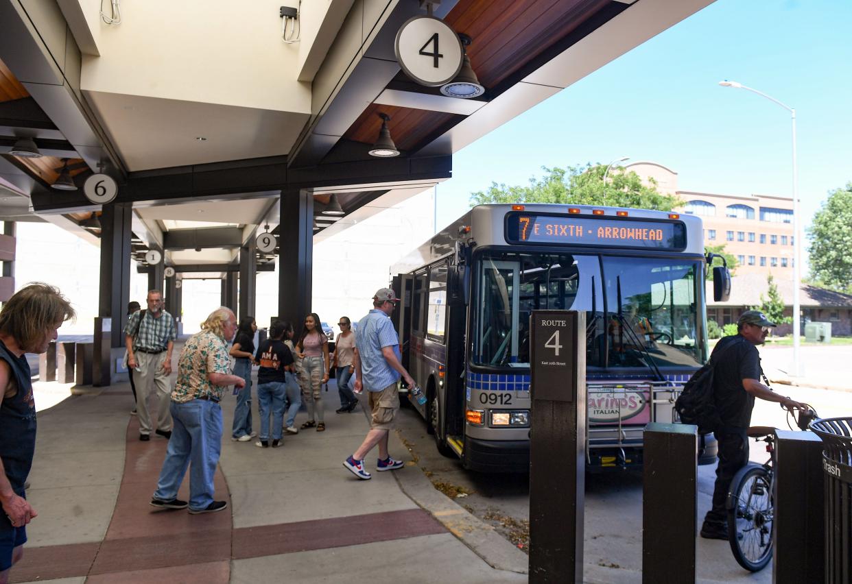 Riders board a city bus on Monday, July 18, 2022, at the downtown bus depot in Sioux Falls.