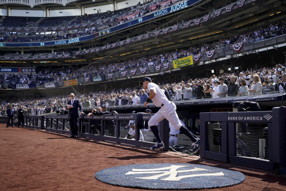 New York Yankees right fielder Aaron Judge (99) is introduced and takes the field before the Yankees opening day baseball game against the Boston Red Sox, Friday, April 8, 2022, in New York. (AP Photo/John Minchillo)