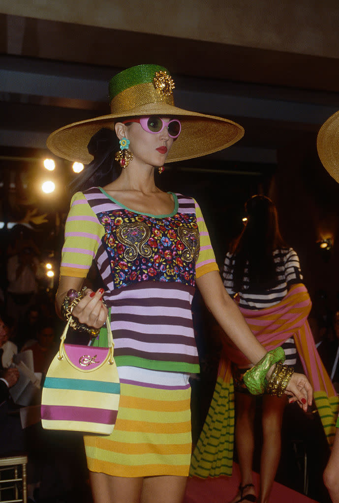 Japanese designer Kenzo Takada shows his women's 1991 spring-summer ready-to-wear line in Paris. The model is wearing a striped skirt and top with a large sun hat. (Photo by Pierre Vauthey/Sygma/Sygma via Getty Images)